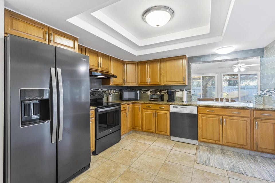 Stunning open-concept kitchen with sleek, appliances, overlooking spacious living and dining areas. Perfect blend of style and functionality!