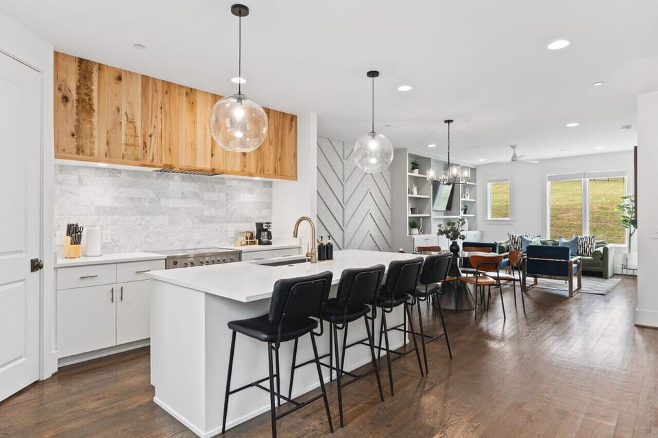 High-end appliances, large pantry, and all the cooking supplies you might need in this bright & fresh kitchen with seating for four at the island.