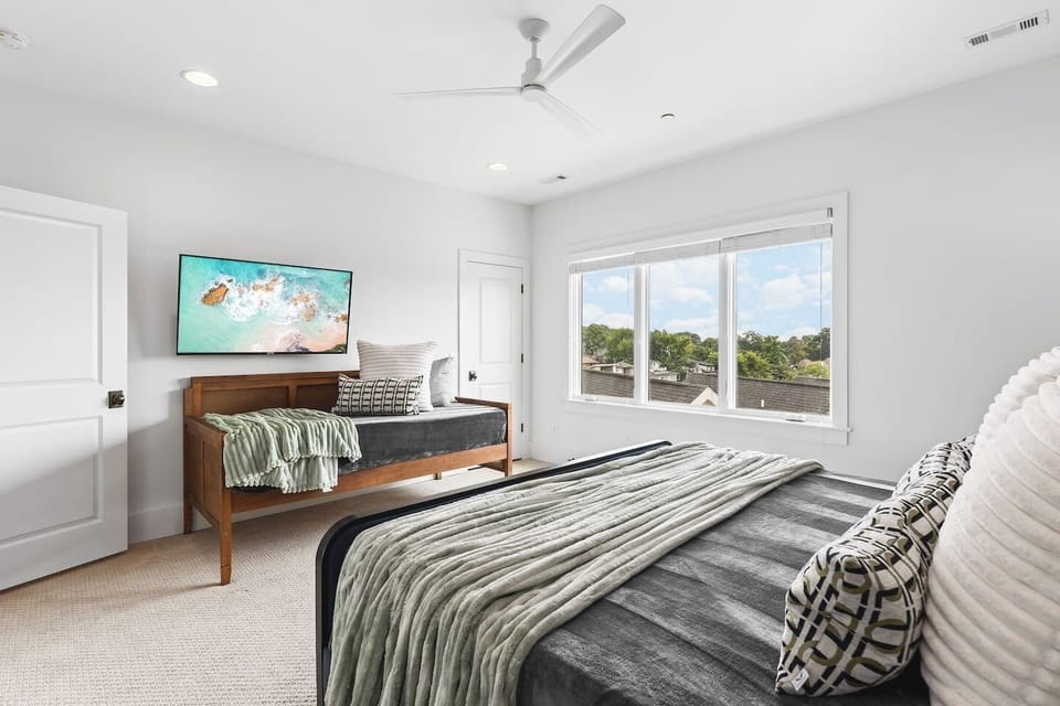 Bedroom #4 on the top floor with a King bed, Twin bed, Smart TV, large ensuite bathroom, and huge walk-in closet.