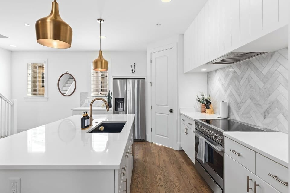 High-end appliances, large pantry, and all the cooking supplies you might need in this bright & refreshing kitchen with seating for four at the island.