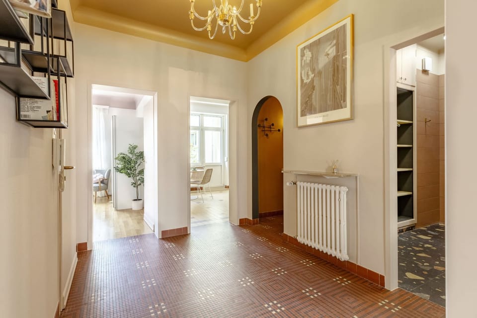 Bright and elegant hallway with tasteful decor and ample natural light, creating a welcoming first impression for guests.