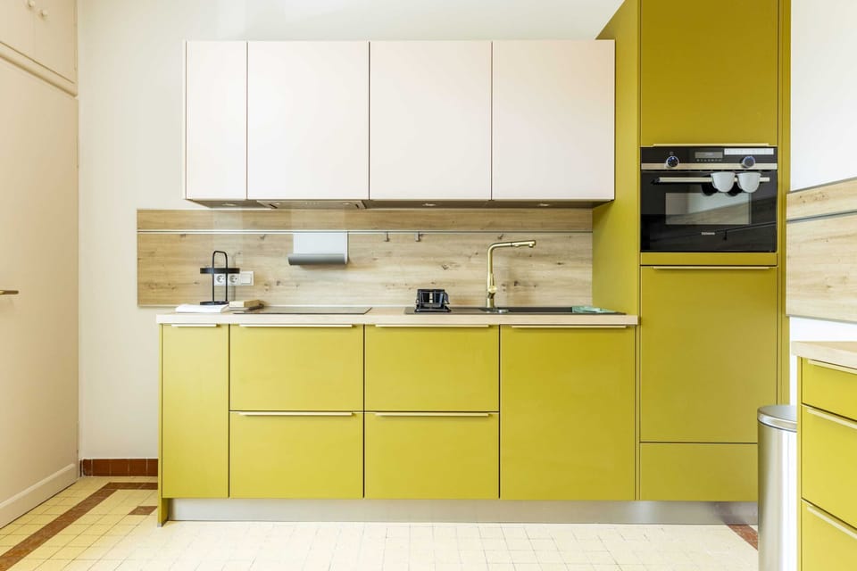 Sleek and modern kitchen equipped with high-end appliances and ample storage, perfect for preparing delicious meals during your stay.