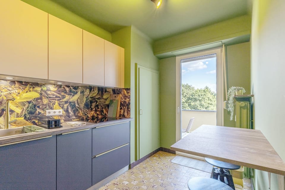 Contemporary kitchen with top-of-the-line appliances and ample counter space, providing a functional and stylish area for preparing delicious meals.