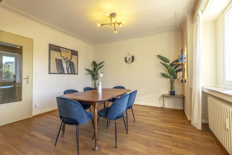 Bright and spacious dining area with modern decor and large windows, perfect for enjoying meals with family or friends in a sunny, inviting setting.