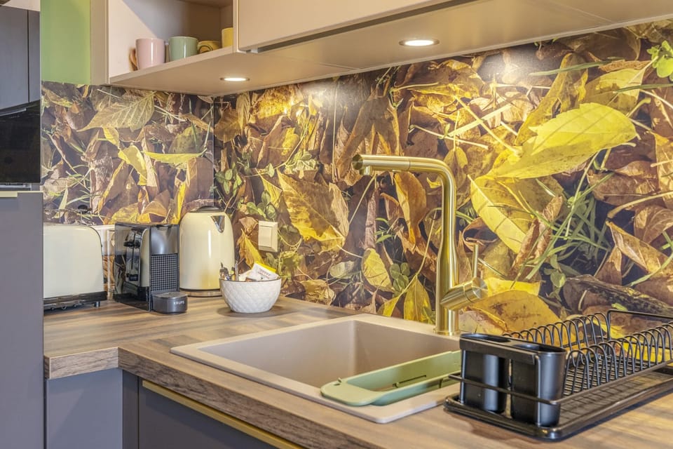 Close-up of the modern kitchen featuring vibrant backsplash, state-of-the-art sink, and convenient appliances, ideal for gourmet cooking