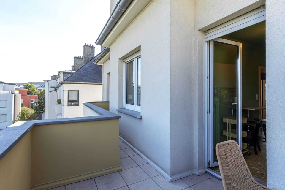 Charming balcony accessible from the living area, perfect for enjoying fresh air and outdoor relaxation with lovely neighborhood views.