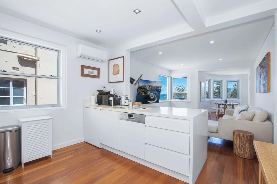 Open plan living space with kitchen island overlooking beautiful Bondi Beach