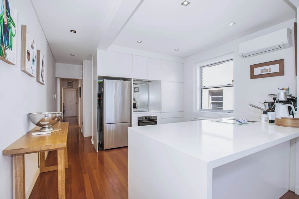 Chefs kitchen with large kitchen island overlooking Bondi Beach