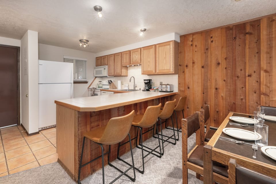 Gather around the warm wood kitchen with breakfast bar seating, where you'll share meals and create memories together.