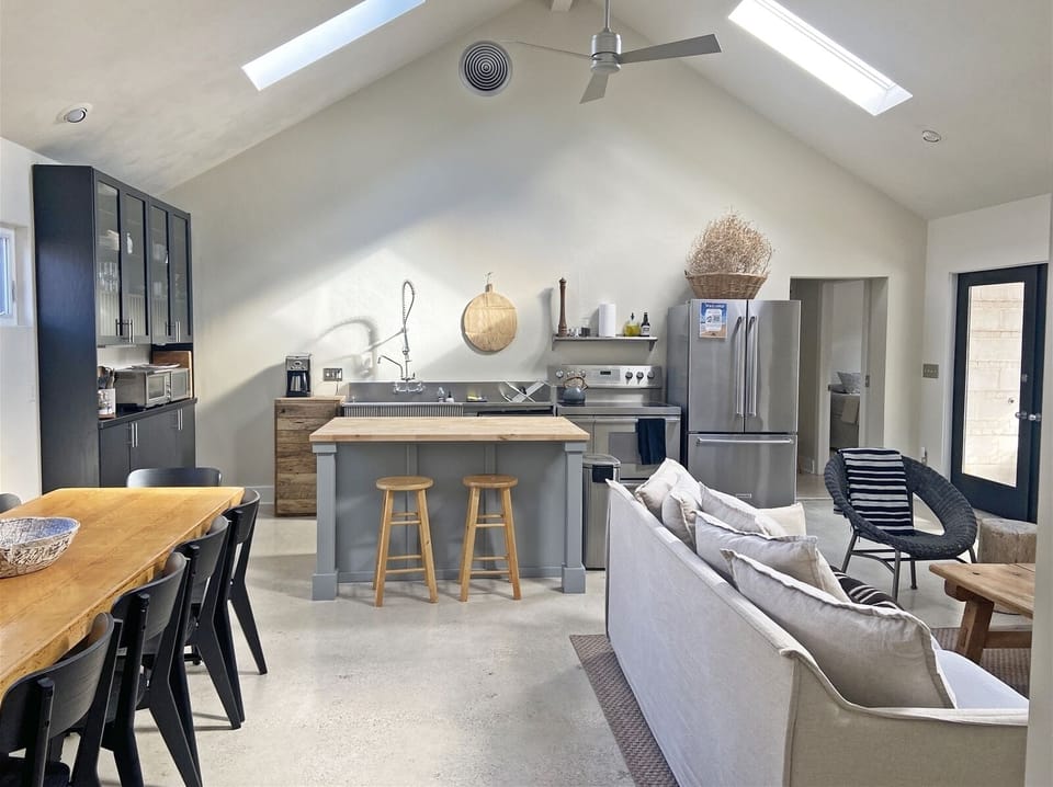 Open living, dining, kitchen area with seasonal fireplace