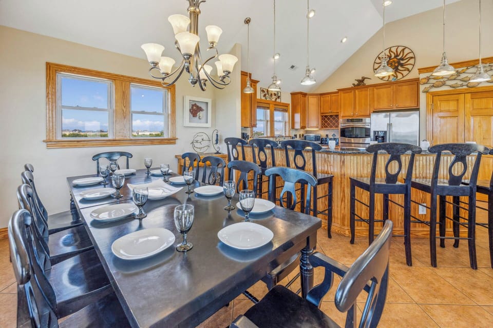 The 10-person dining table is conveniently located directly next to the kitchen and breakfast counter.
