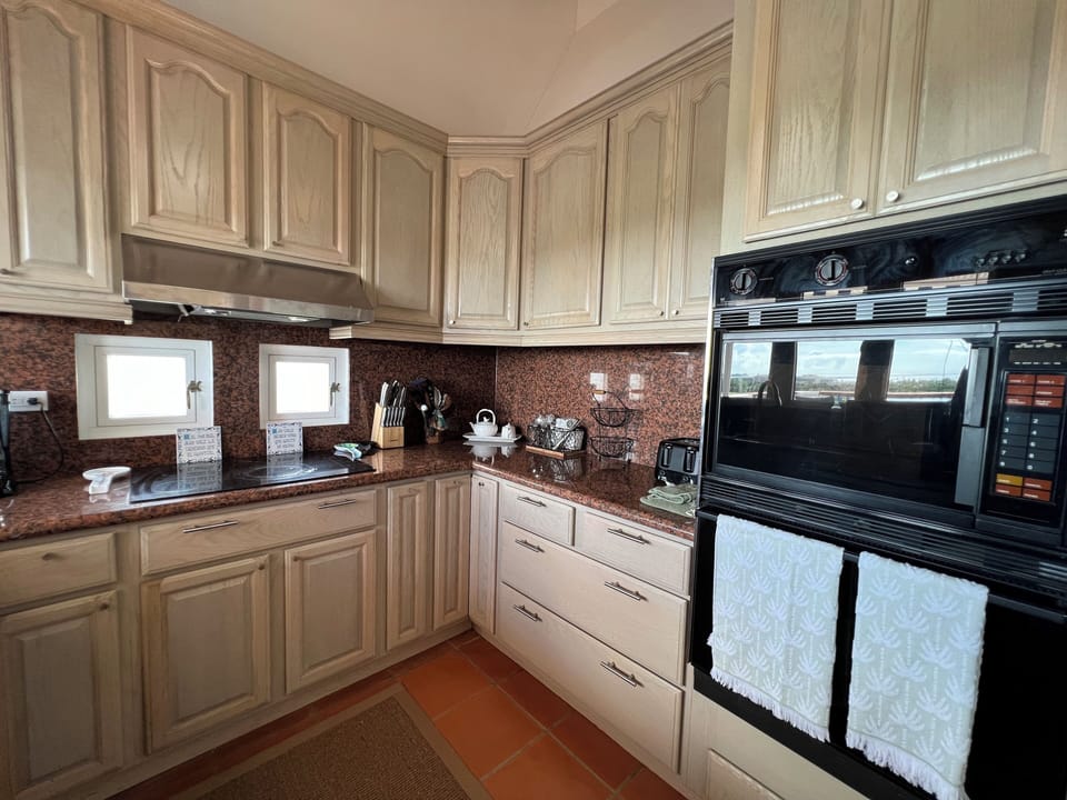Oven, microwave, toaster, knives, coffee maker. 