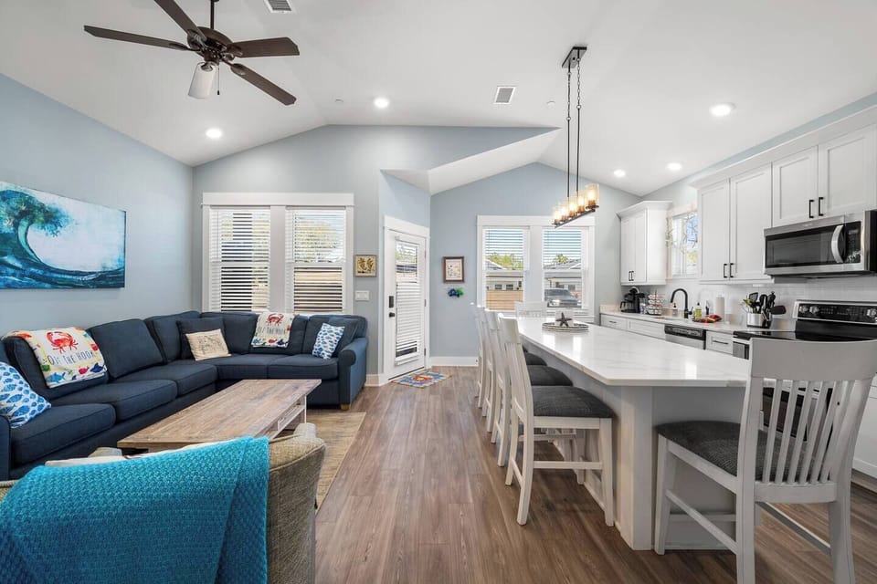 Open-concept living room, dining area, and fully equipped kitchen