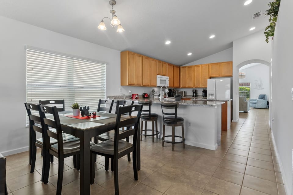 Modern kitchen with appliances, granite countertops, and breakfast bar.