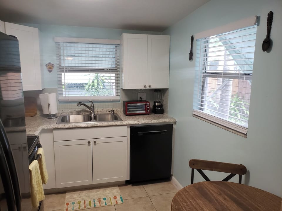 Fully stocked kitchen with updated appliances including a Bosch dishwasher. 