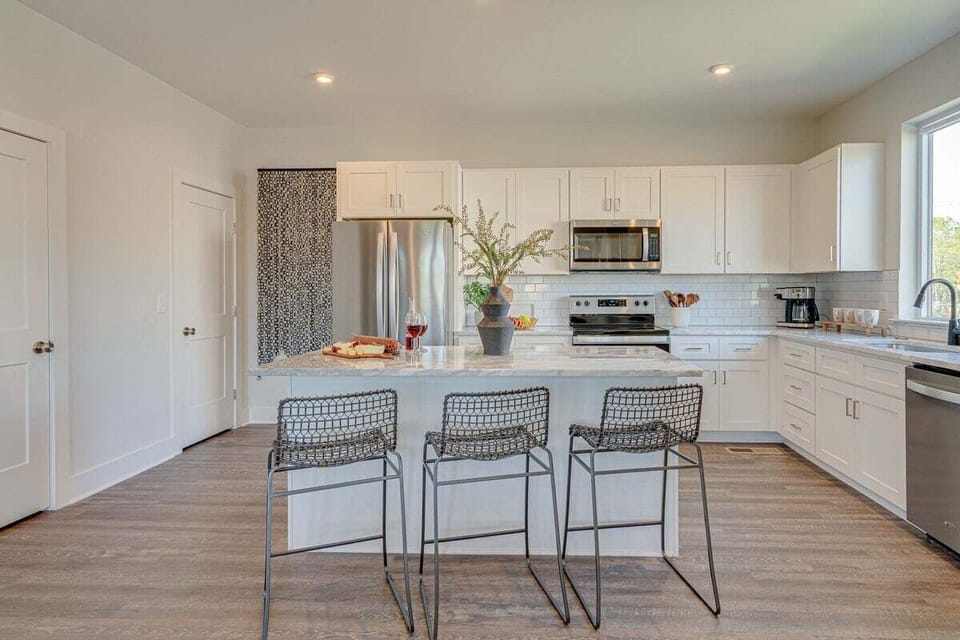 Fully equipped kitchen stocked with basic cooking essentials and stainless steel appliances.