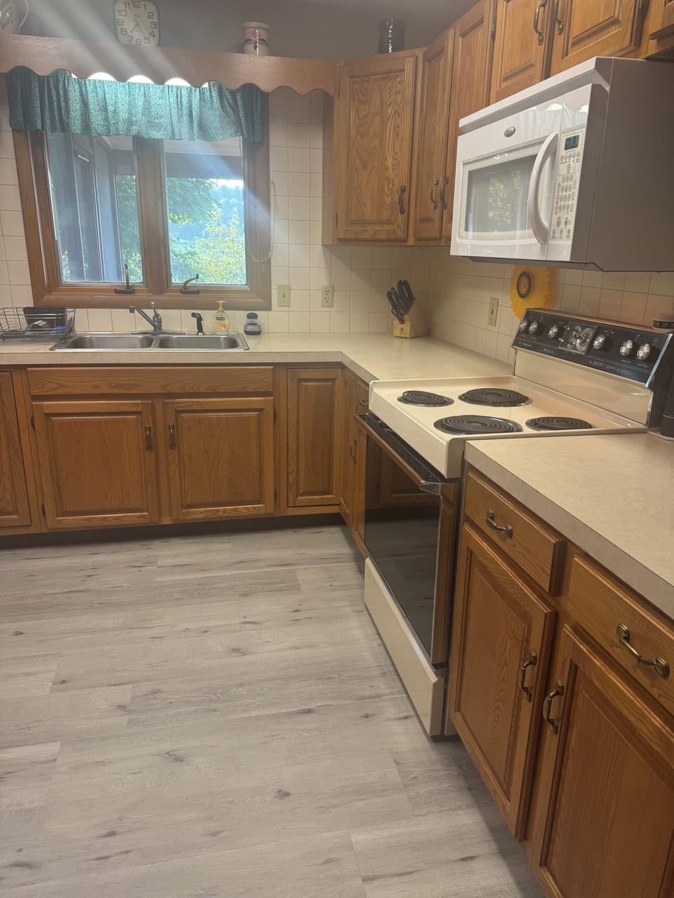 Kitchen with refrigerator, oven, stove, and microwave