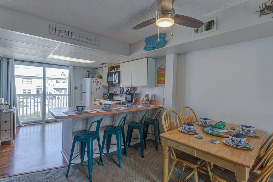 Dining table and breakfast bar are great for family meals, board games, or planning your day over coffee and donuts