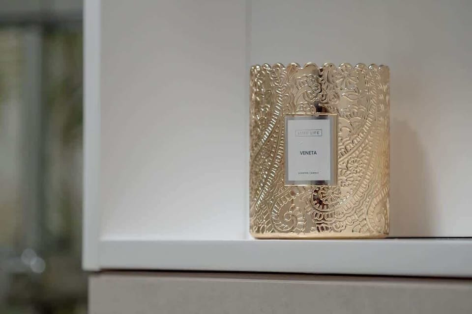 A decorative light switch framed in an ornate golden frame, adding a quirky, luxurious detail to the interior.