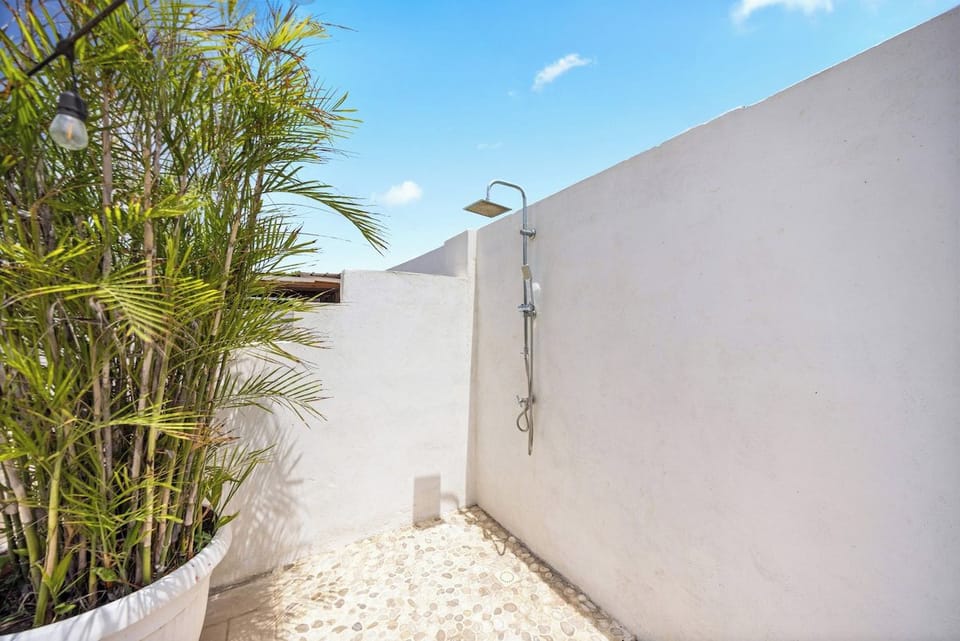 Experience modern elegance in this beautifully appointed bathroom of the home in Oranjestad, Aruba - Stay organized with plenty of storage space for your personal care items - Impeccably clean and maintained, ensuring a comfortable experience
