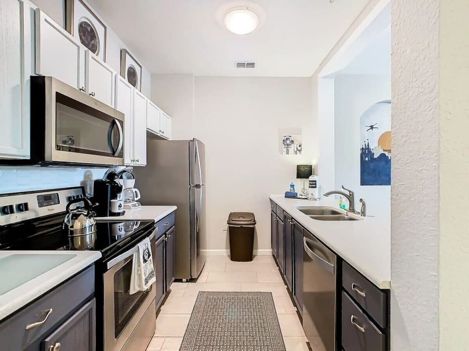 Fully equipped kitchen area with a spacious fridge and oven, perfect for preparing your favorite meals with ease.