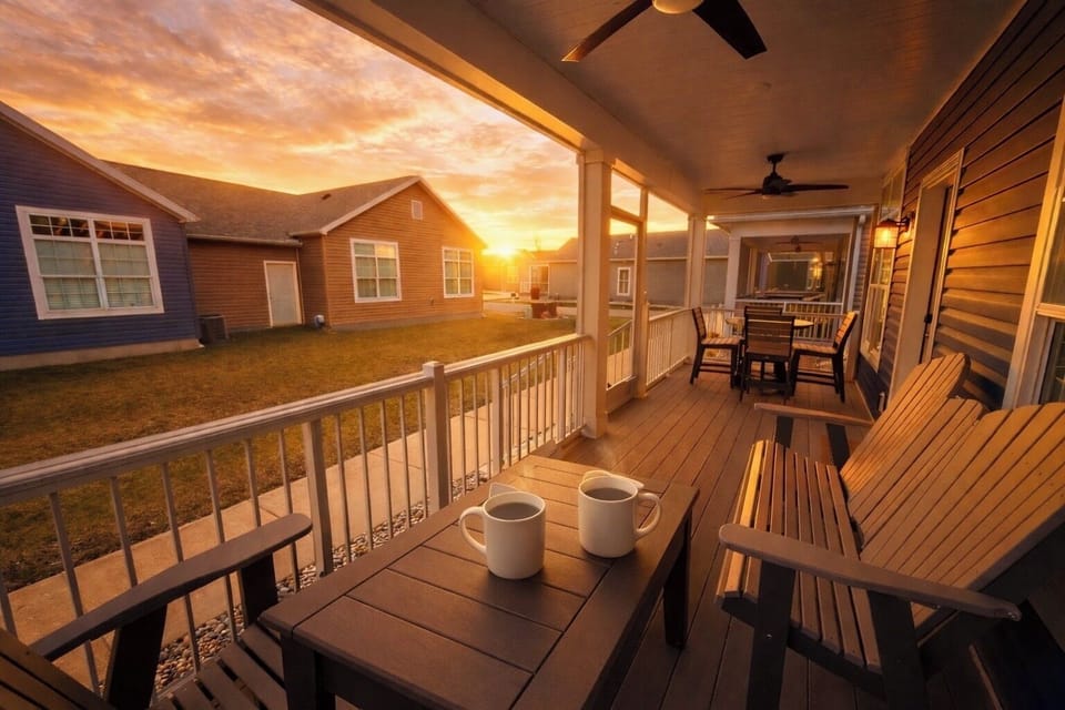 Charming exterior at sunset with a welcoming front porch and warm lighting—ideal for relaxing evenings and capturing that perfect vacation vibe.