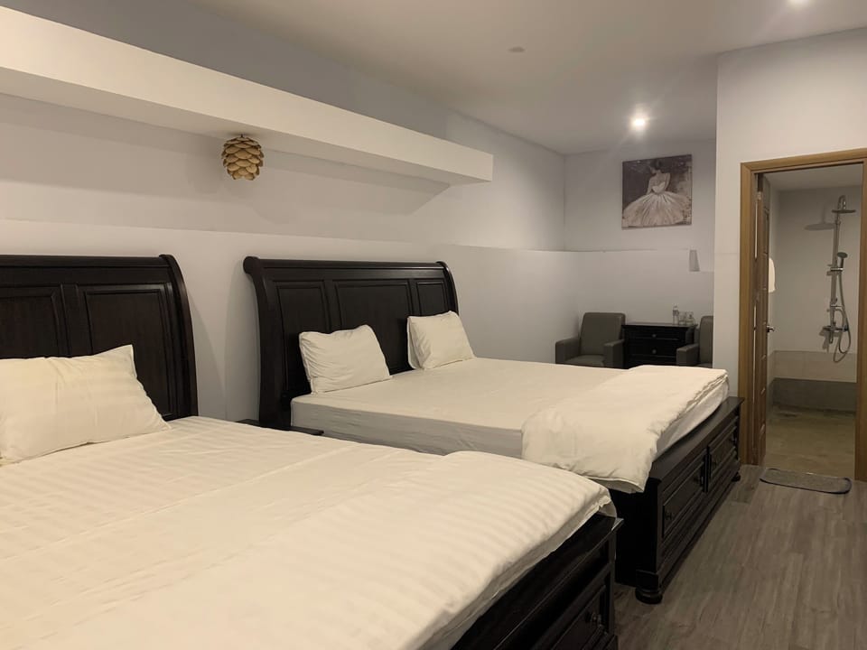 Deluxe Quadruple Room, 2 Queen Beds | Blackout drapes, soundproofing, iron/ironing board, WiFi (free)