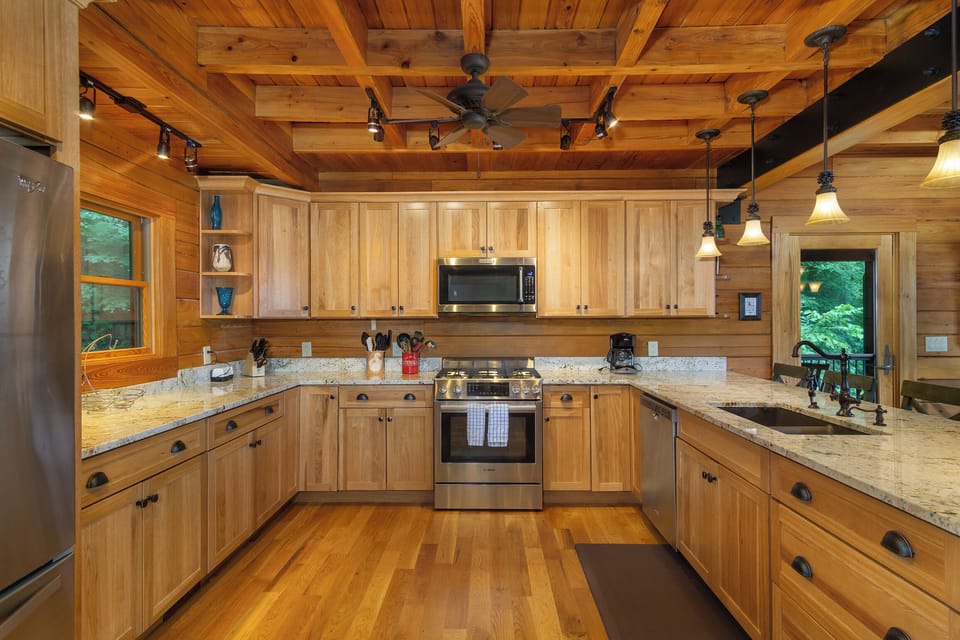 Gourmet kitchen with gas range stove, dishwasher & drip-style coffeemaker.