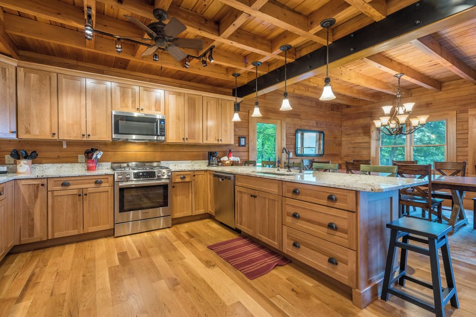 Gourmet kitchen with gas range stove, dishwasher & drip-style coffeemaker.
