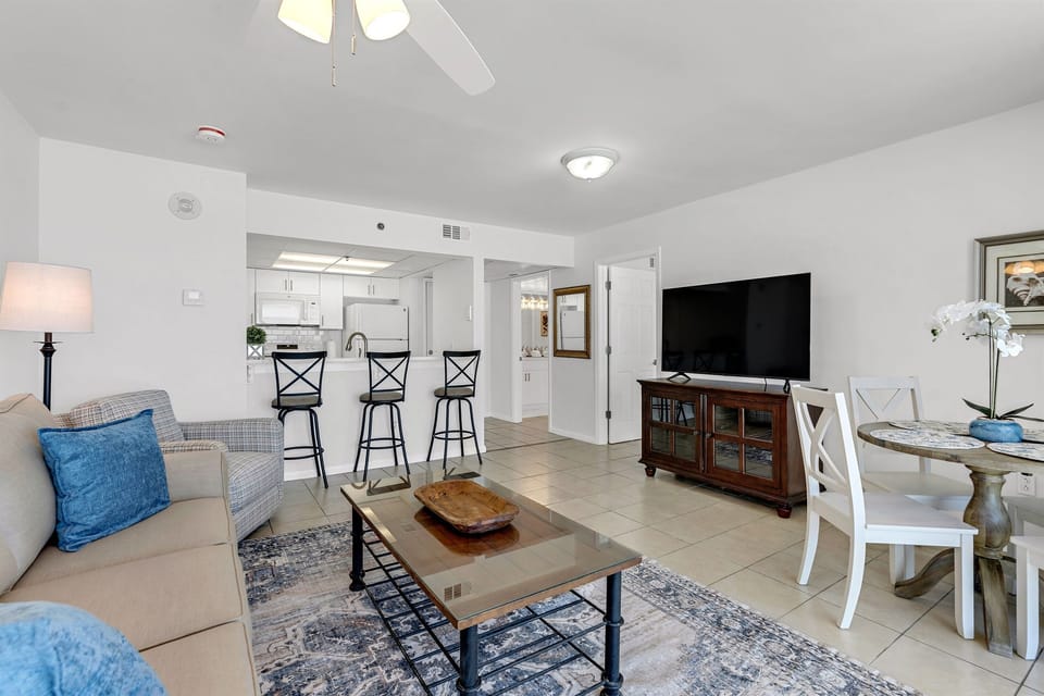 Unwind in your open-concept haven with comfortable seating, modern kitchen, and entertainment center for memorable evenings.