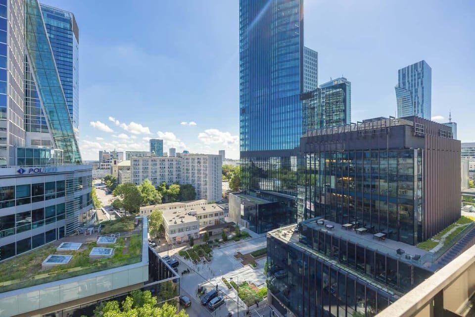 A cityscape view featuring modern high-rise buildings and glass facades on a sunny day.
