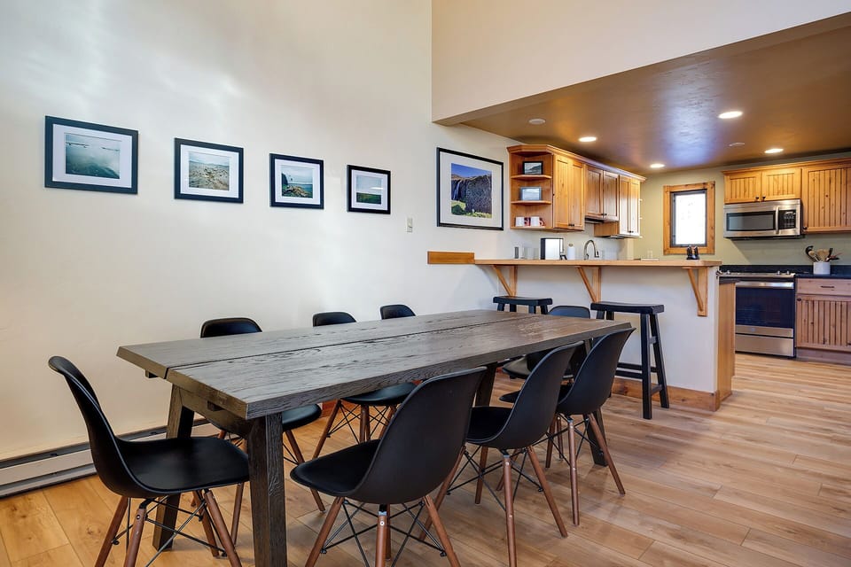 Gather around this stunning rustic dining table where your group can share meals and make memories in this open, light-filled space.