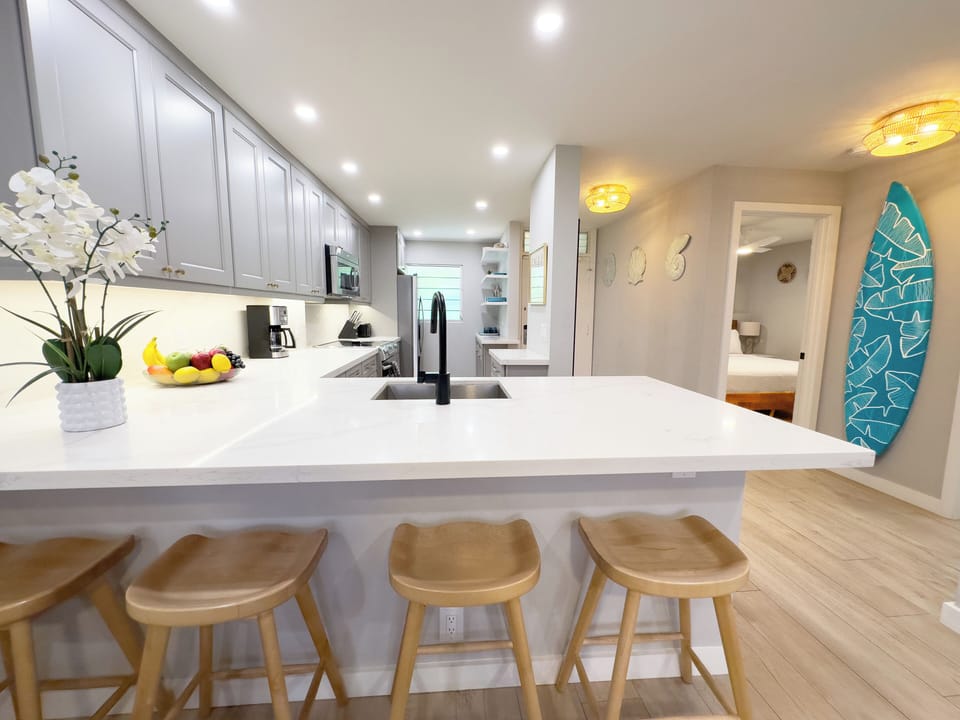 Provide appetizers and delicious cocktails at the bar for your guests while preparing a memorable Hawaiian meal.