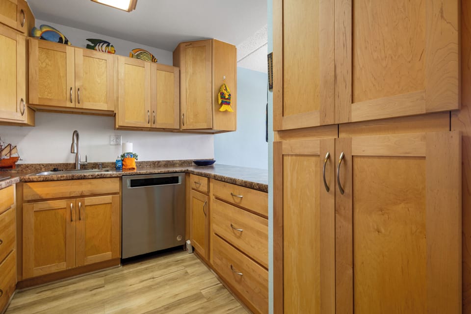 Your fully equipped kitchen features warm wood cabinetry, granite countertops, stainless appliances, and ample storage—everything you need to prepare meals just the way you like them.