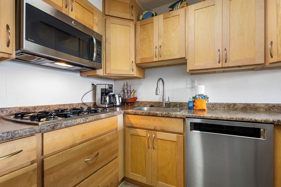 Your fully equipped kitchen features granite countertops, stainless steel appliances, and warm wood cabinetry—everything you need to prepare delicious home-cooked meals during your stay.