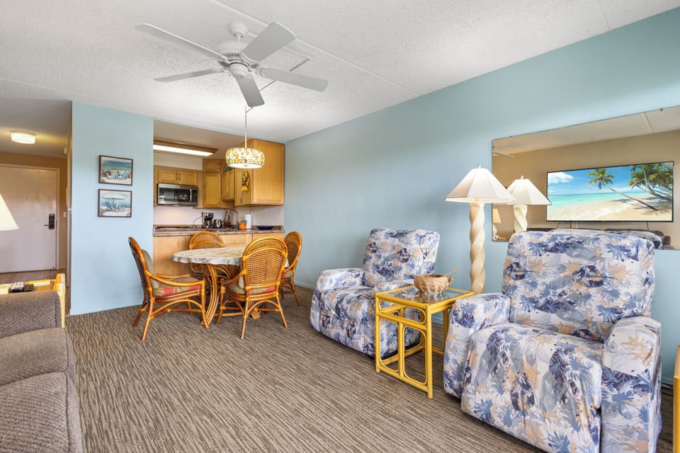 Unwind in your bright, open-plan living area featuring comfortable seating and a convenient dining space perfect for family meals and island relaxation.