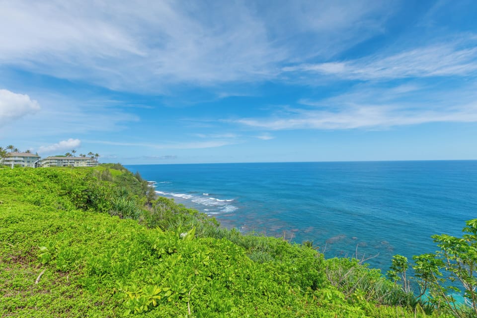 This picturesque spot offers an unobstructed panorama of the sparkling blue sea, perfect for enjoying sunrises, sunsets, or simply soaking in the serene coastal scenery.