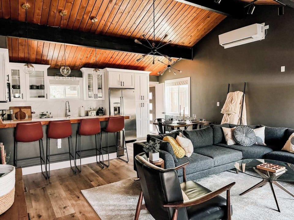 Plush blankets and a plush couch highlight this super comfy and open living room
