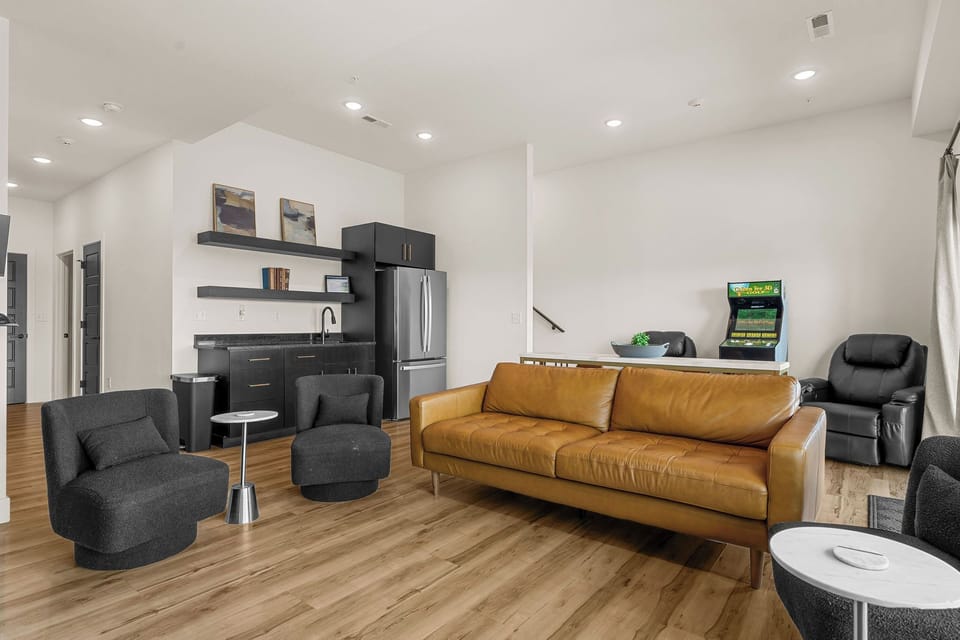 Wet bar and full refrigerator located beside the golf simulator for added convenience.

