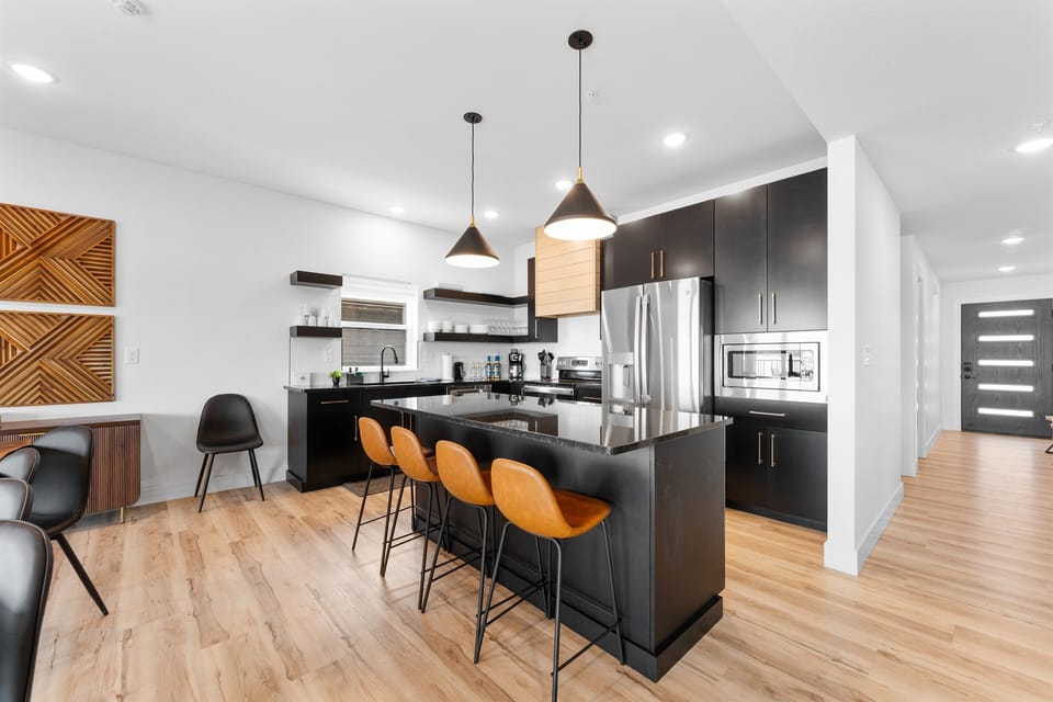 Fully stocked open kitchen with plenty of prep space—great for making meals together and enjoying time around the table.