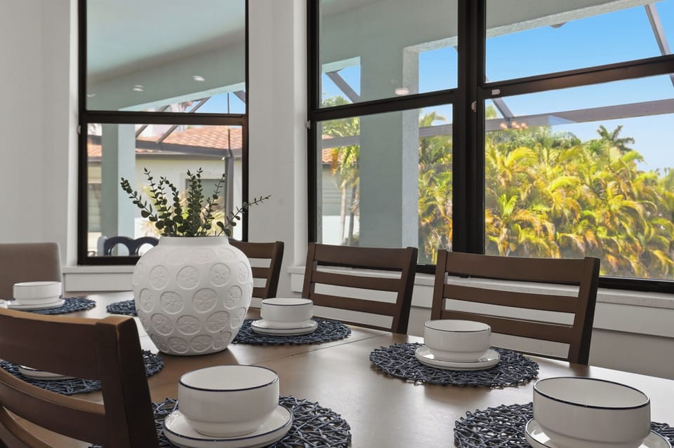 8 Man table plus 6 barstools at the breakfast bar located inside