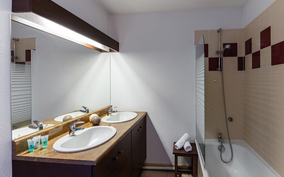 The bathroom is bright and has everything you need to get ready for your day.
