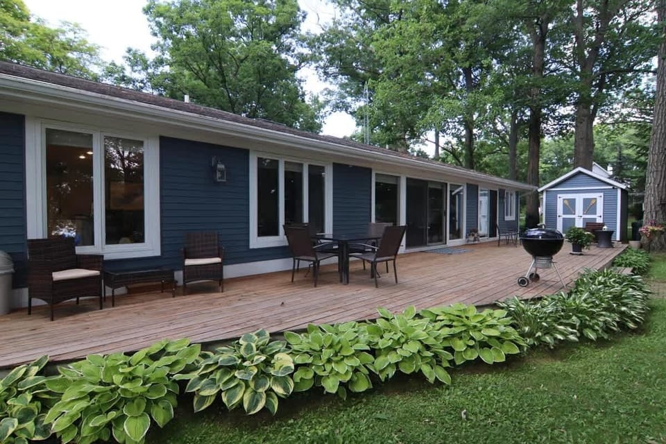 Relax on the back patio with dining table and additional seating. The charcoal grill is ready for entertaining!