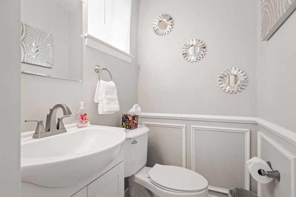 Convenient half bathroom located on the first floor, just off the kitchen.