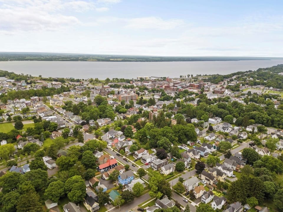 Outdoor - A stunning aerial view of Geneva, NY, showcasing the beautiful Seneca Lake and the charming neighborhood, perfect for those seeking a serene and picturesque setting.