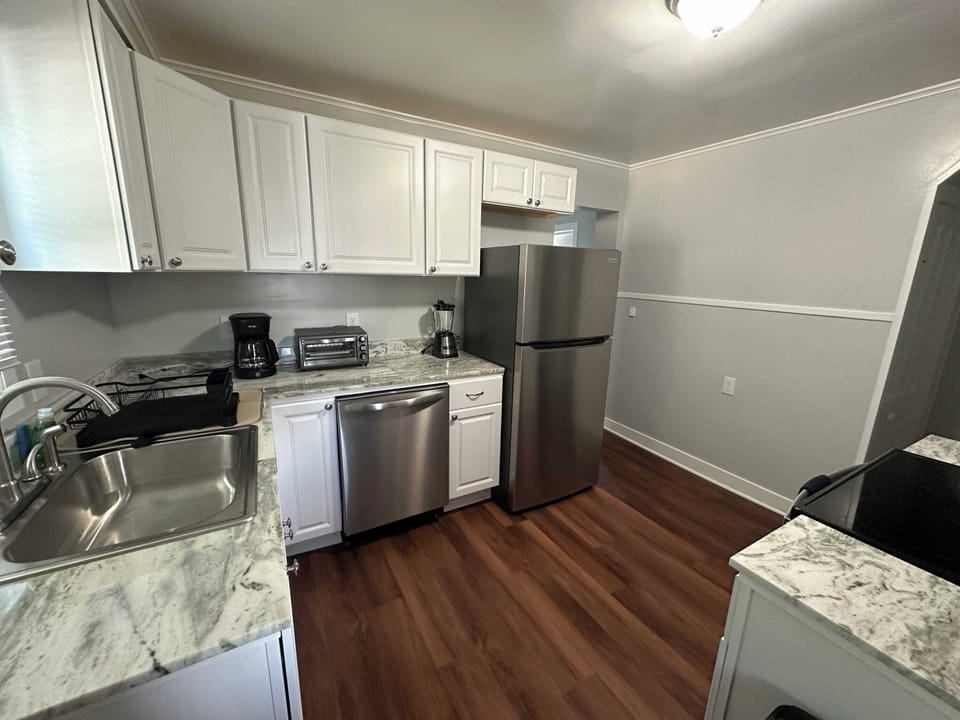This fully equipped kitchen has everything you need to prepare meals, featuring modern appliances, cooking utensils, pots, pans, and all the essentials for a stress-free cooking experience.