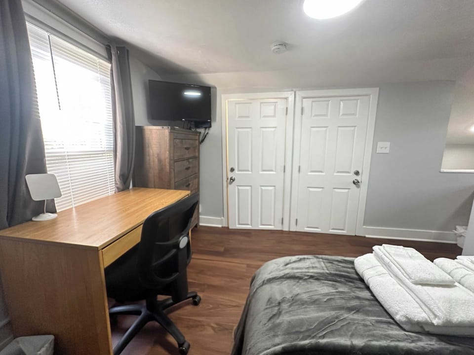 Bedroom #3; Upstairs features two loft-like bedrooms designed with a shared wall to create individual, private spaces within a modern layout.
