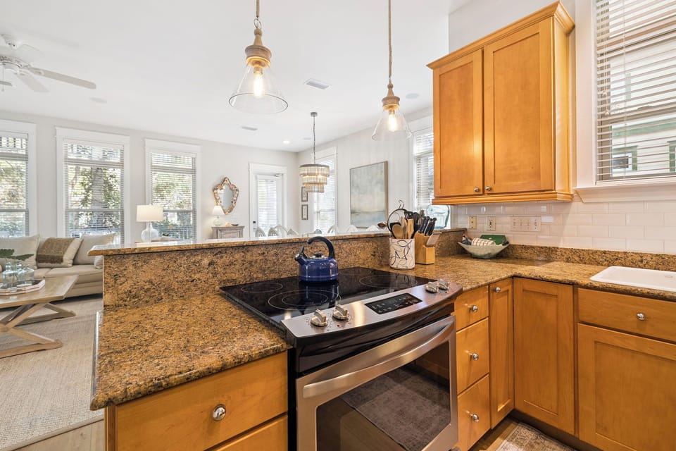 Your fully equipped kitchen features granite counters, stainless appliances, and pendant lighting—perfect for creating memorable meals during your stay.