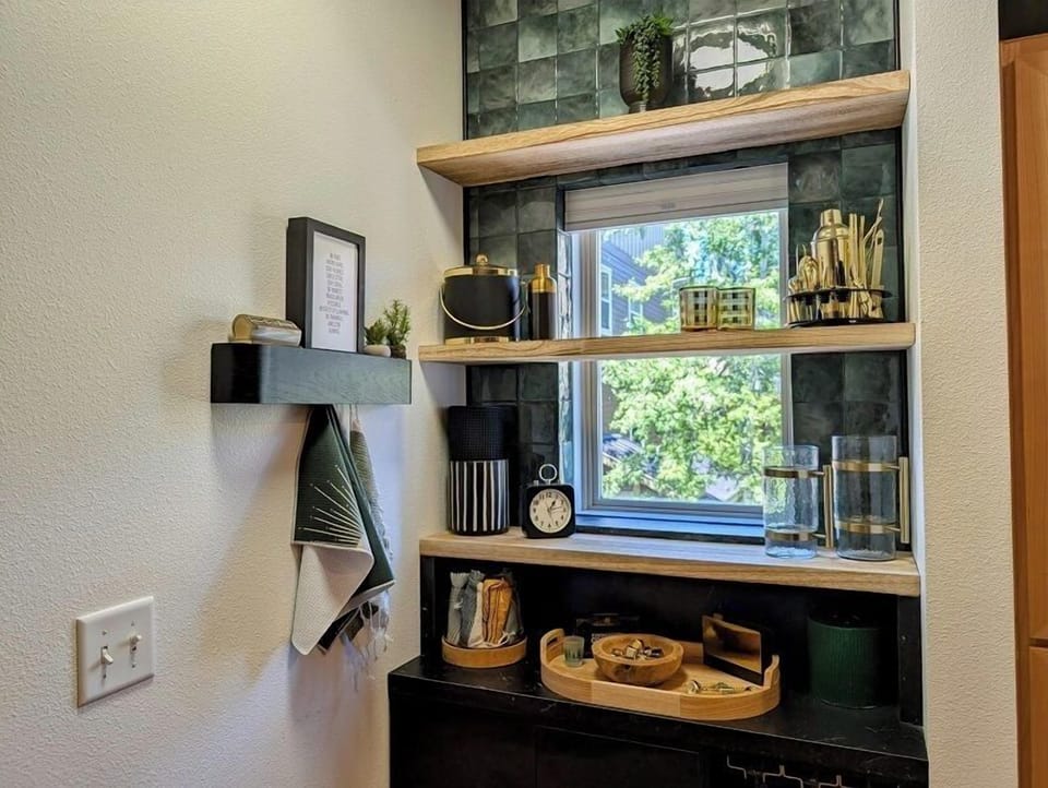 Custom-built bar area with wine glasses and other amenities.
