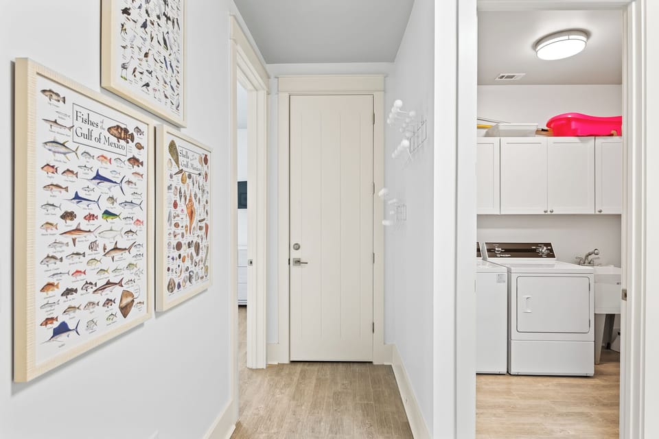 Hallway with view of the laundry room.